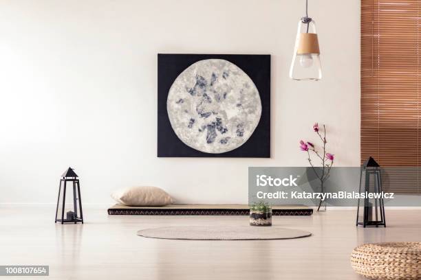 Bright And Simple Bedroom Interior With Asian Style Tatami Mat Bed Cherry Blossom Moon Painting On White Wall And Black Lanterns Real Photo Stock Photo - Download Image Now