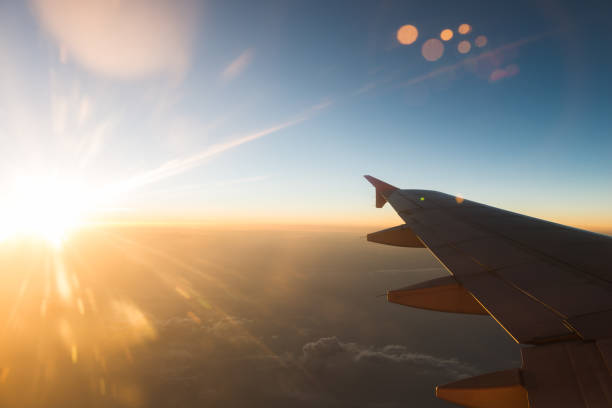 istock The plane is flying through the sunset sky 1008107852