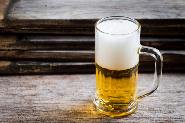 istock mug of beer on wood background 1008108060