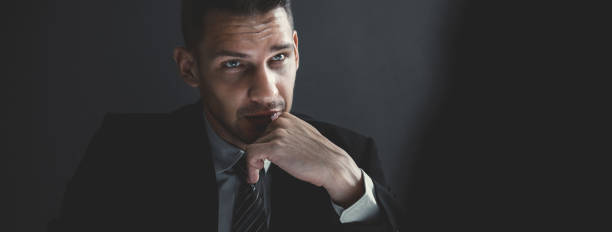 istock Man in shadow with serious face staring at interlocutor 1008108156