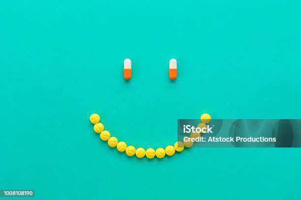 Kapseln Und Pillen In Smilng Gesicht Angeordnet Stockfoto und mehr Bilder von Glücklichsein - Glücklichsein, Tablette, Medikamenten-Kapsel