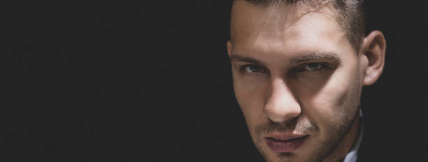 istock Tricky sly man face in dark room 1008108250