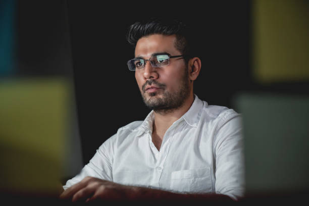Asian businessman concentrating on working at night
