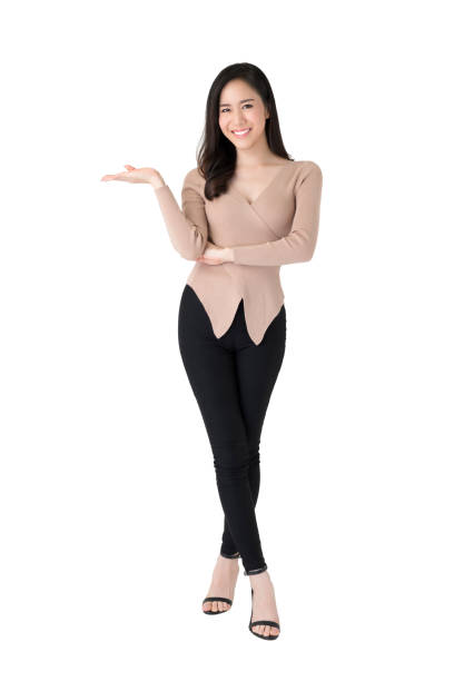 Beautiful confident Asian woman standing with open palm gesture