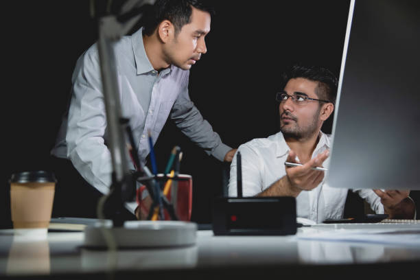 istock Aasian businessman coworkers discussing work at night 1008108476