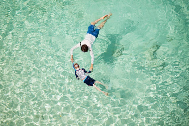 istock family snorkeling together 1008108480