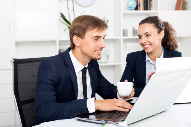 istock Man and woman coworkers working on computers 1008113816