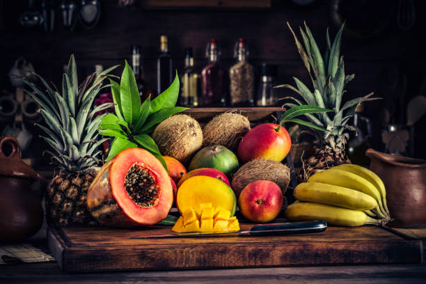 istock Wooden crates with assorted tropical fruits in rustic kitchen. Natural lighting 1008131148