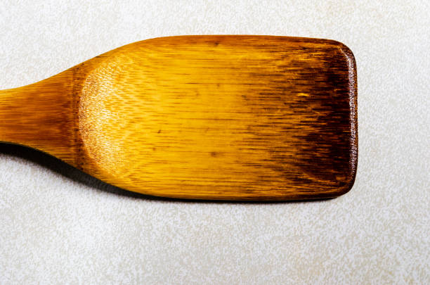istock horizontal single weathered wooden spatula on a gray patterned background 1008135674