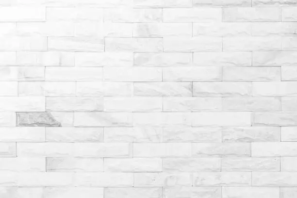 Photo of Cream and white brick wall texture background. Brickwork or stonework flooring interior rock old pattern clean concrete grid uneven bricks design stack.