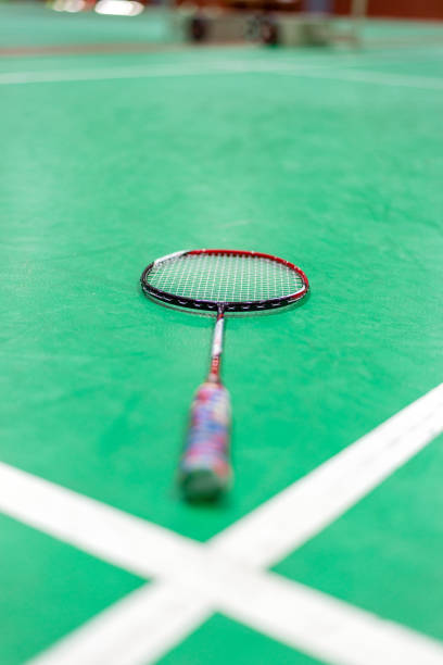 istock badminton racket on green court. 1008183816