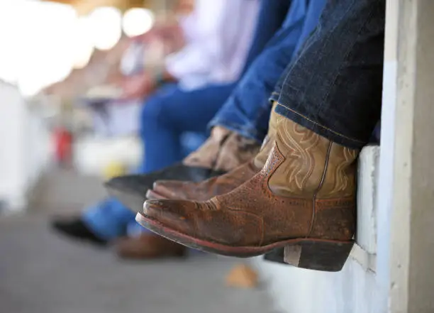 Cowboy boots at rodeo over edge