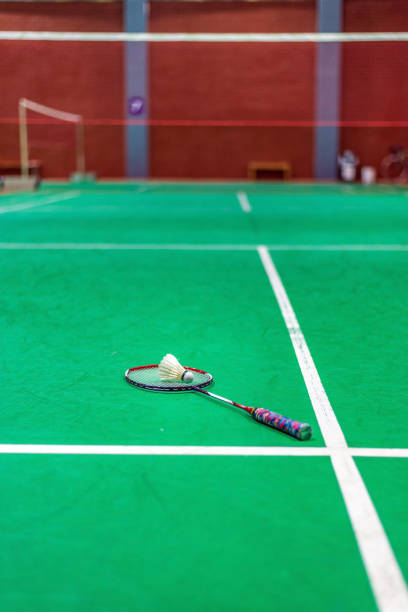 istock badminton shuttlecock and racket on green court 1008185998