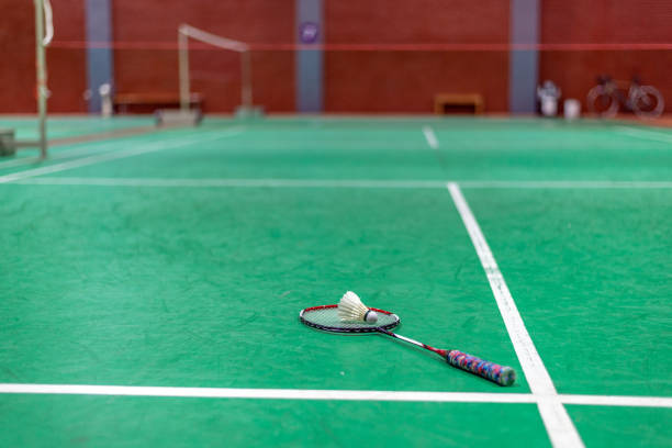 istock badminton shuttlecock and racket on green court 1008186042