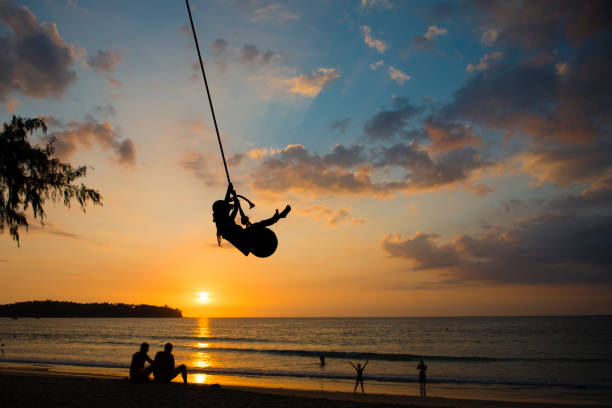 istock Child playing swings at Sunset Beach 1008199424