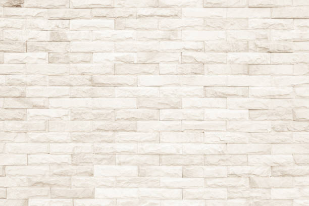 istock Cream and white brick wall texture background. Brickwork or stonework flooring interior rock old pattern clean concrete grid uneven bricks design stack. 1008202294