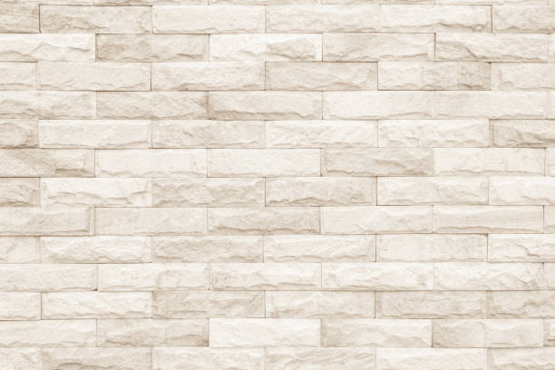 istock Cream and white brick wall texture background. Brickwork or stonework flooring interior rock old pattern clean concrete grid uneven bricks design stack. 1008202314