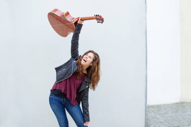 istock Ecstatic female guitar player celebrating success 1008207634