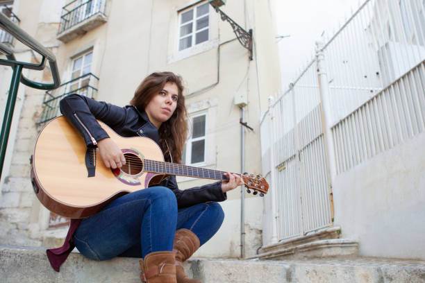 istock Pensive female musician performing in street 1008207648