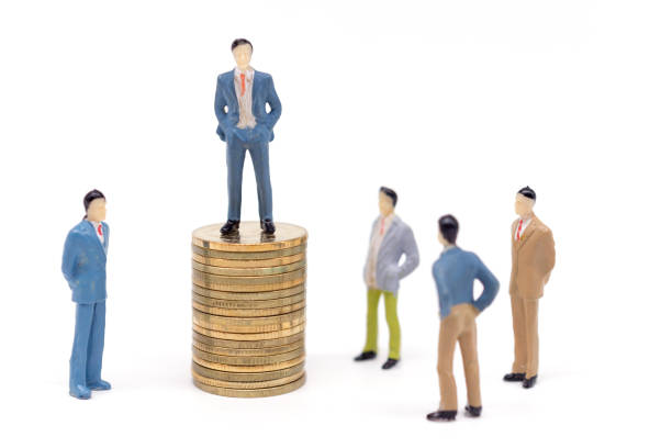 istock Miniature businessman and coins on white background 1008209746