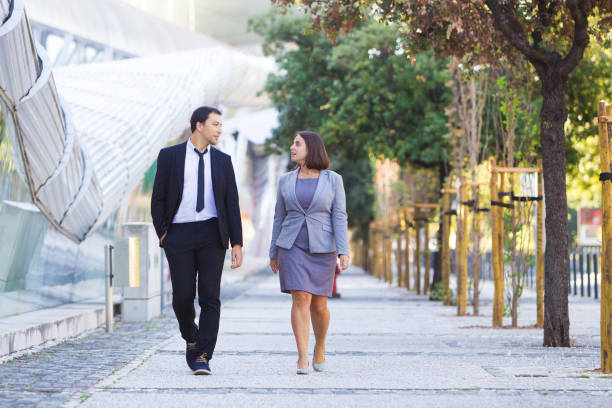 istock Serious businessman sharing ideas with colleague during stroll 1008209856