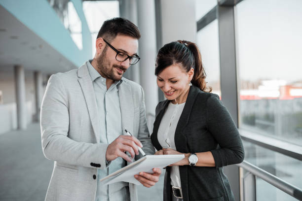 istock Two smiling business people talking about investment. 1008212972