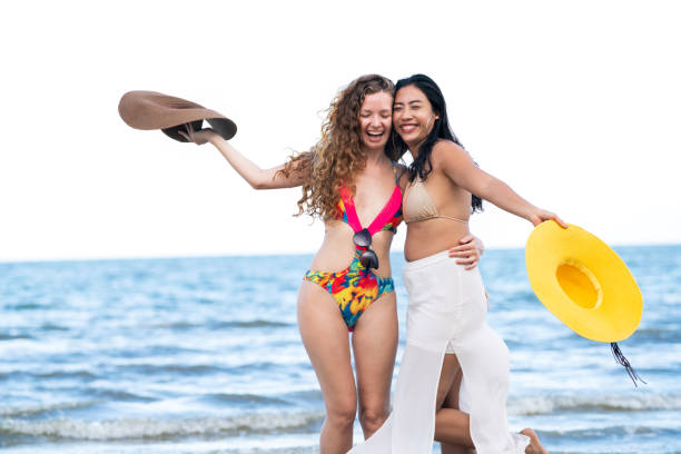 istock Happy women dance on sand beach in summer. 1008213306