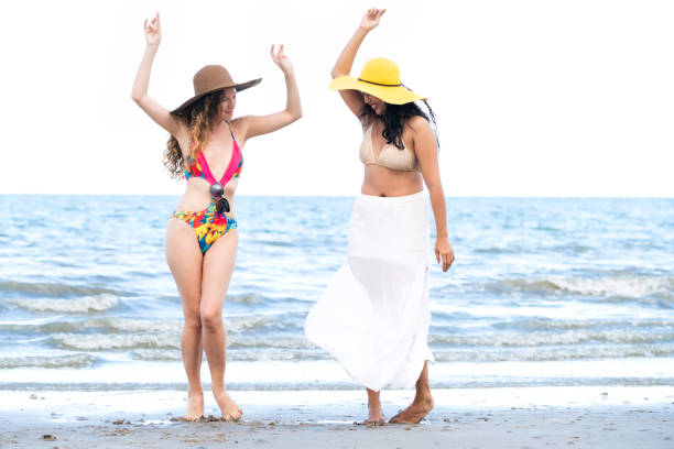 istock Happy women dance on sand beach in summer. 1008213308