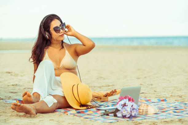 istock Plus size young woman sitting on the beach. 1008215698