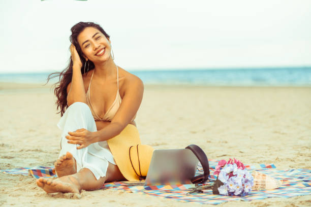 istock Plus size young woman sitting on the beach. 1008215726
