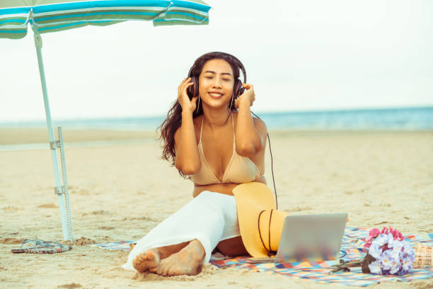 istock Plus size young woman sitting on the beach. 1008215740