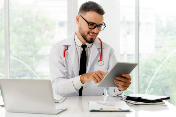 Doctor working on tablet computer in the hospital.