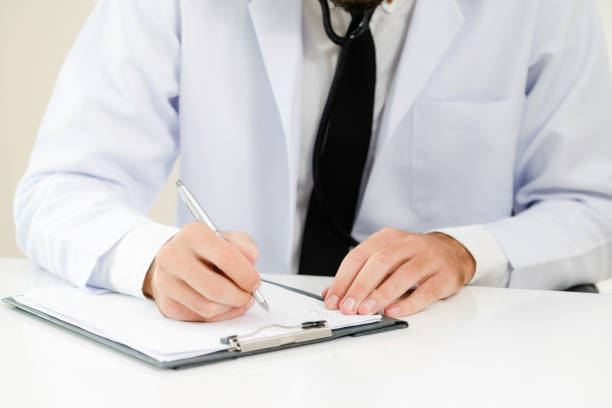 istock Doctor in hospital writing on a paper document. 1008220298