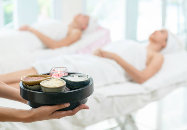 istock Massage therapist with hot spa treatment set. 1008223210