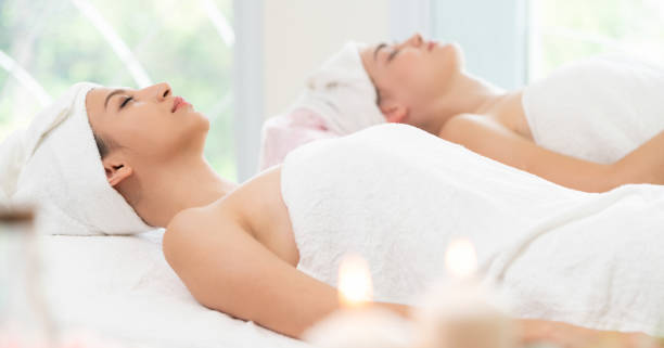 istock Relaxed young woman lying on spa bed for massage. 1008223230