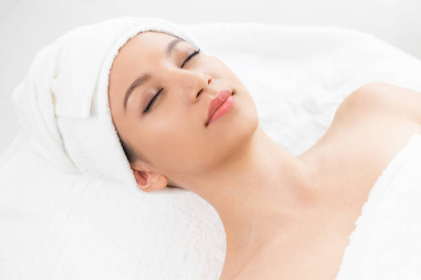 istock Relaxed young woman lying on spa bed for massage. 1008223236