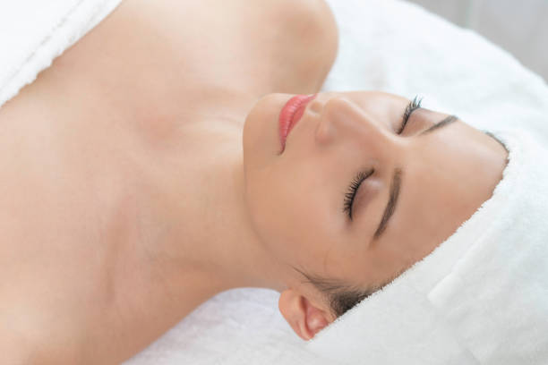 istock Relaxed young woman lying on spa bed for massage. 1008223276