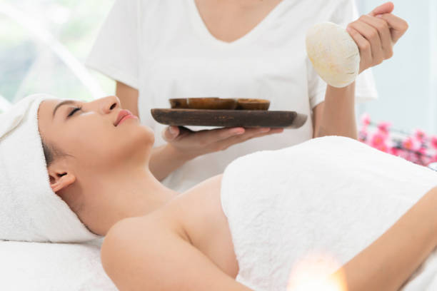 istock Massage therapist using herbal compress with woman 1008223342