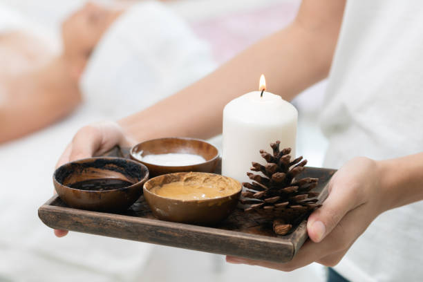 istock Massage therapist with hot spa treatment set. 1008223370