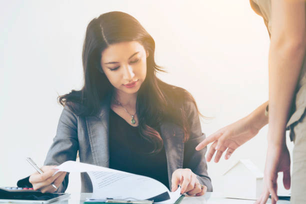 istock Businesswoman reads and talks with partner. 1008223518