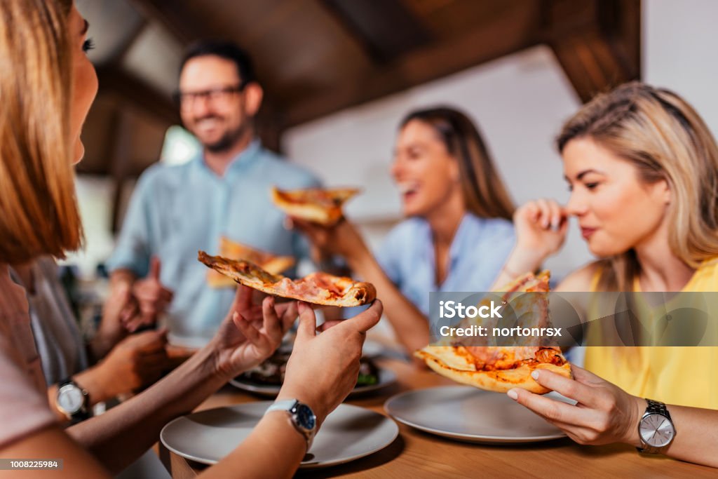 Close-up image of group of friends or colleagues eating pizza. Pizza Stock Photo