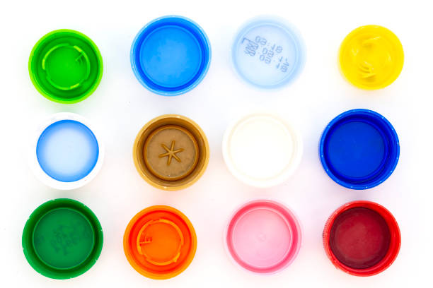 Colorful plastic bottle caps Colorful plastic bottle caps. Studio shot. Plastic waste. Isolated on a white background. bottle cap stock pictures, royalty-free photos & images