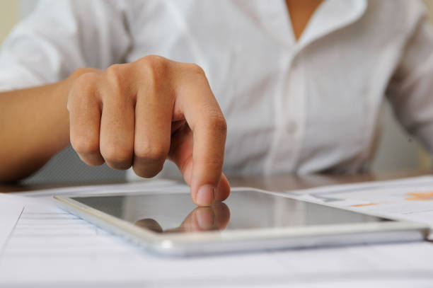 istock Closeup of person tapping on touchscreen 1008226494