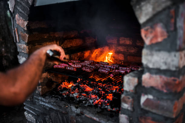istock Close-up image of meat kebab cooking on a stone fireplace grill. 1008226590
