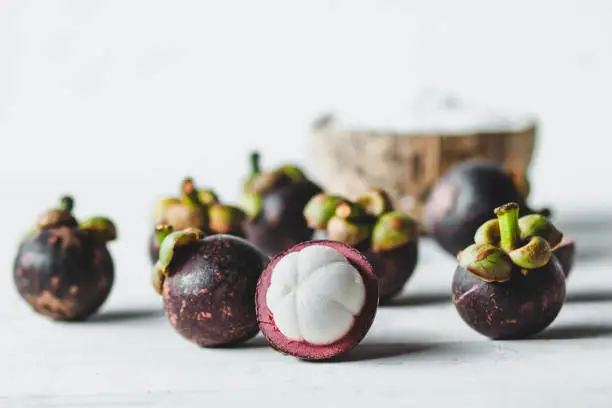 Natural Mangosteen On white wood