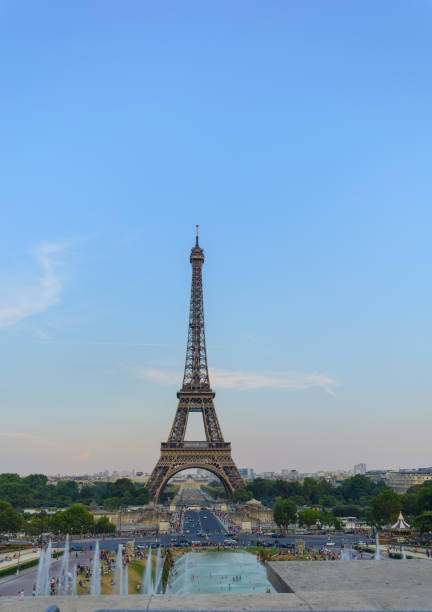 istock Eiffel tower with water sprinkler and golden light from setting sun 1008234592