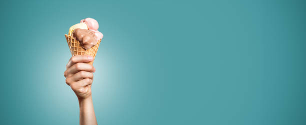 istock Hand holding an ice cream cone panorama 1008234776