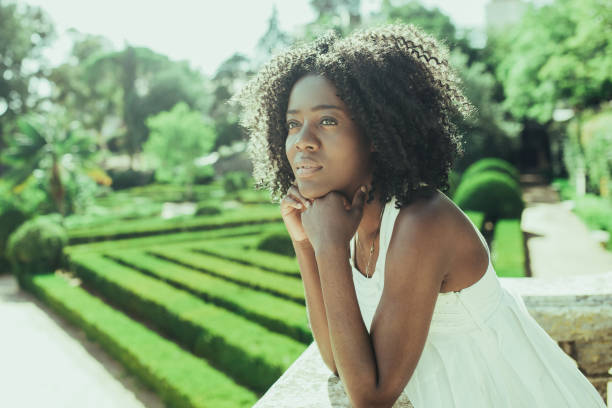 istock Dreamy Pretty Black Woman Relaxing in Park 1008234814