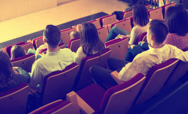istock Cheerful audience expecting movie to begin 1008235316