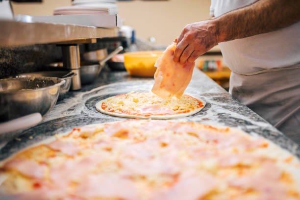 istock Delicious pizza preparation. Close-up. 1008235400